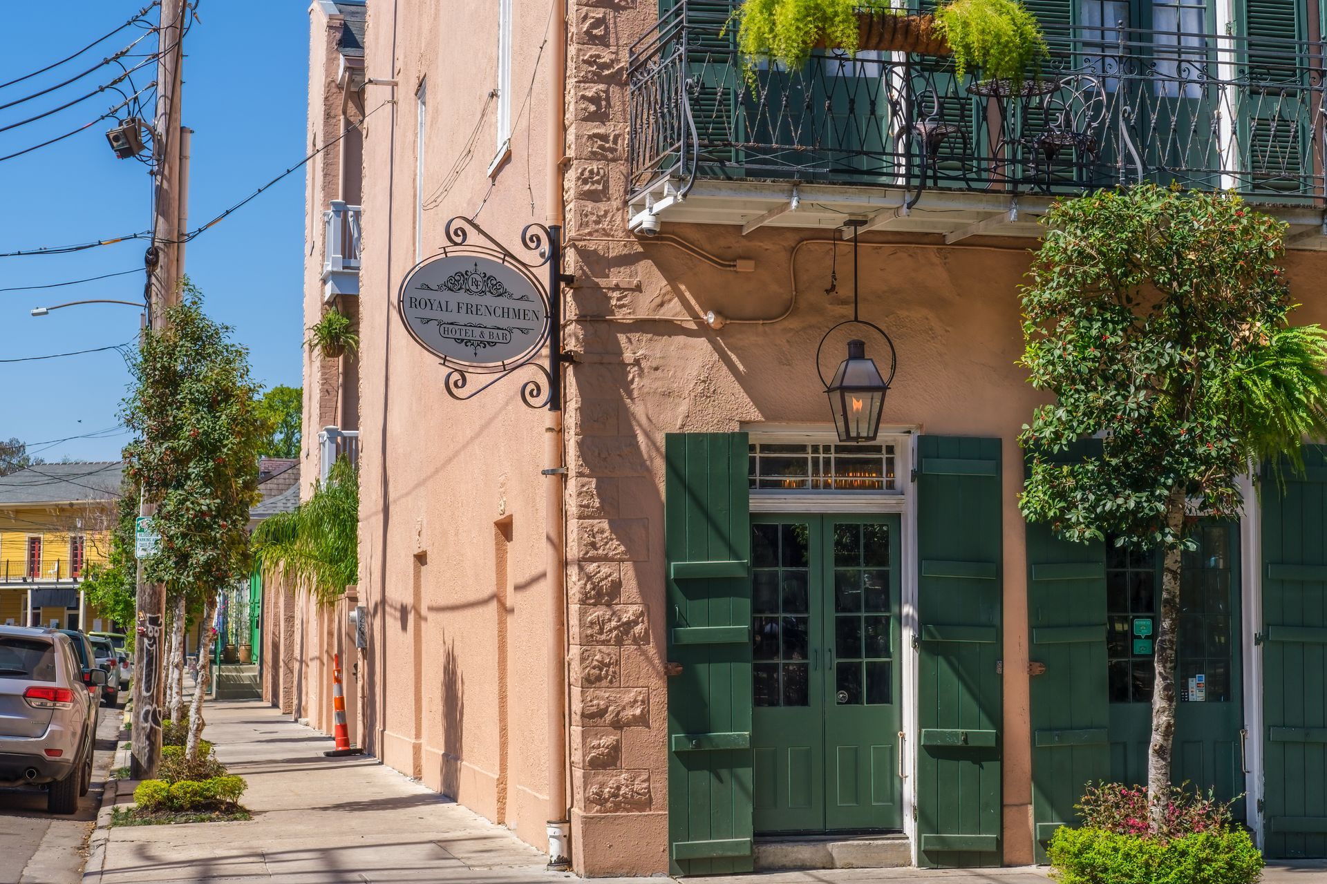A building with green shutters and a sign on the side of it.