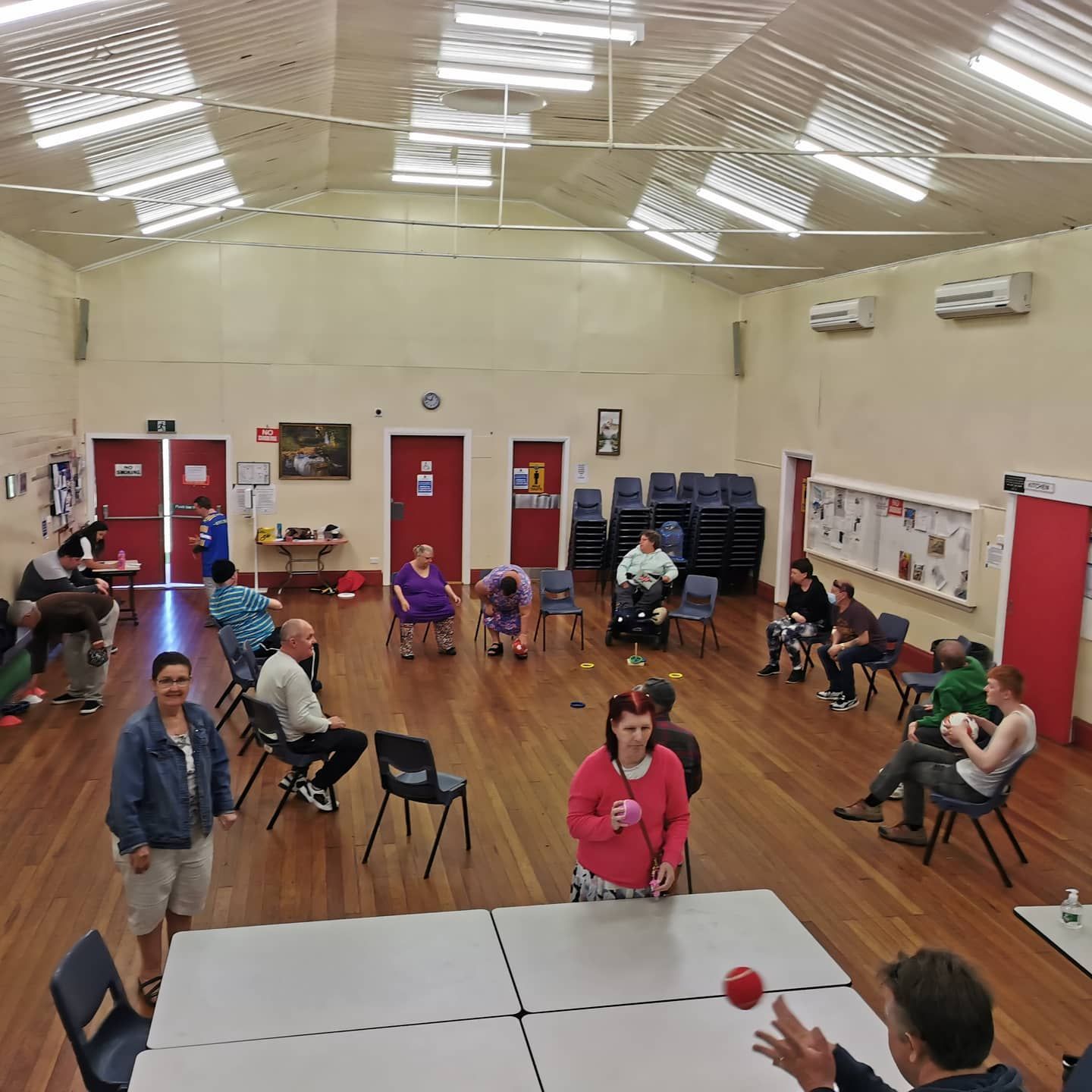 A Group of People Are Sitting Around Tables in a Large Room —True Form Fitness In Gwandalan, NSW