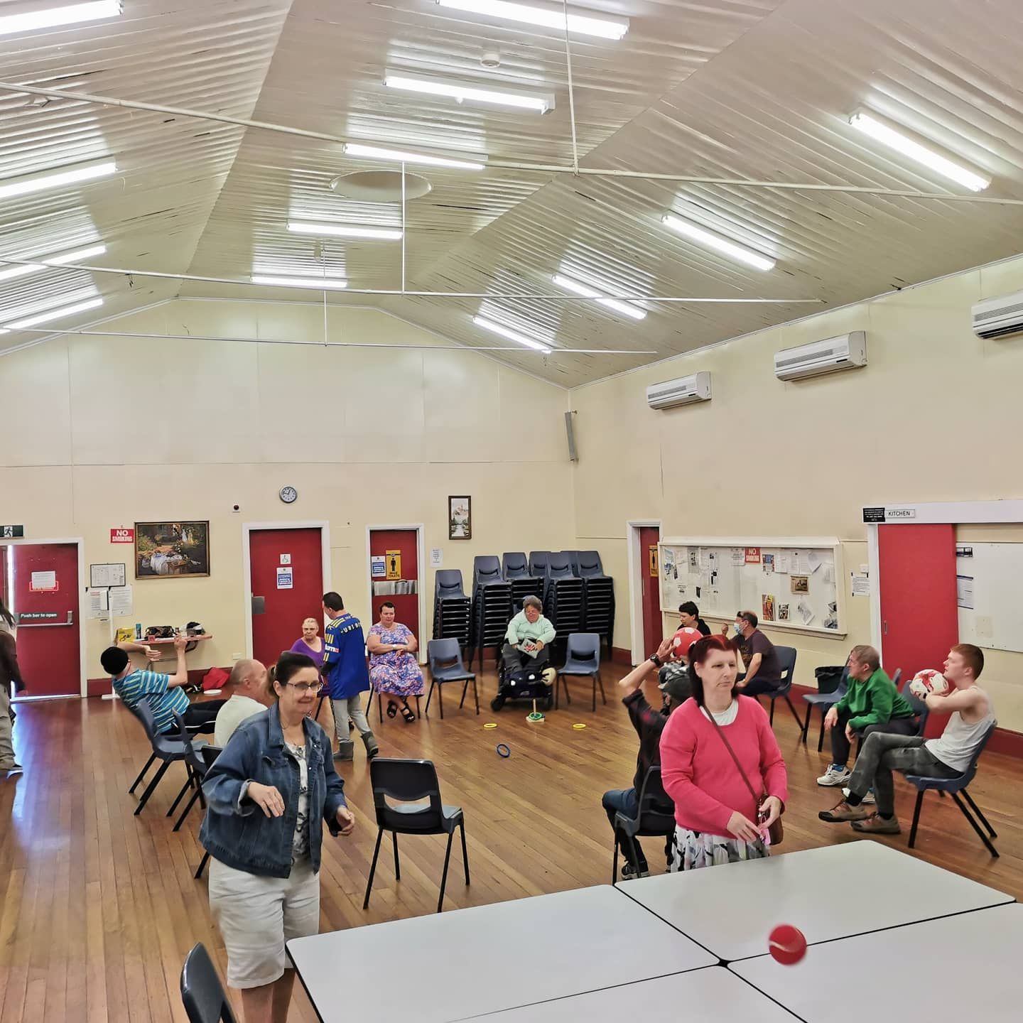 A Group of People Are Gathered in a Large Room With Tables and Chairs —True Form Fitness In Gwandalan, NSW