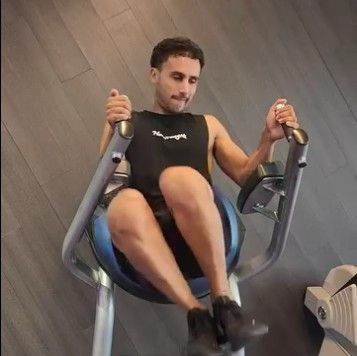 A Man is Sitting on a Machine in a Gym —True Form Fitness In Gwandalan, NSW