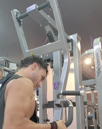A Man is Using a Machine in a Gym —True Form Fitness In Gwandalan, NSW