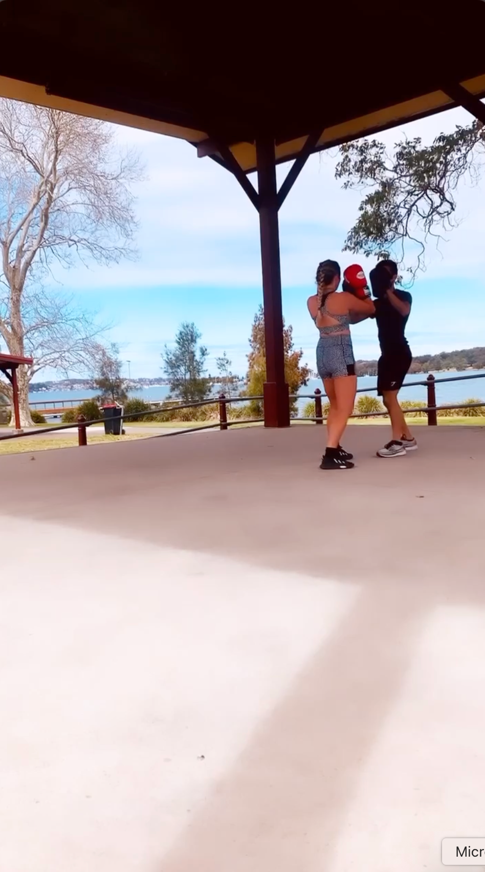 Two people boxing in an outdoor pavilion with a lake view —True Form Fitness In Gwandalan, NSW