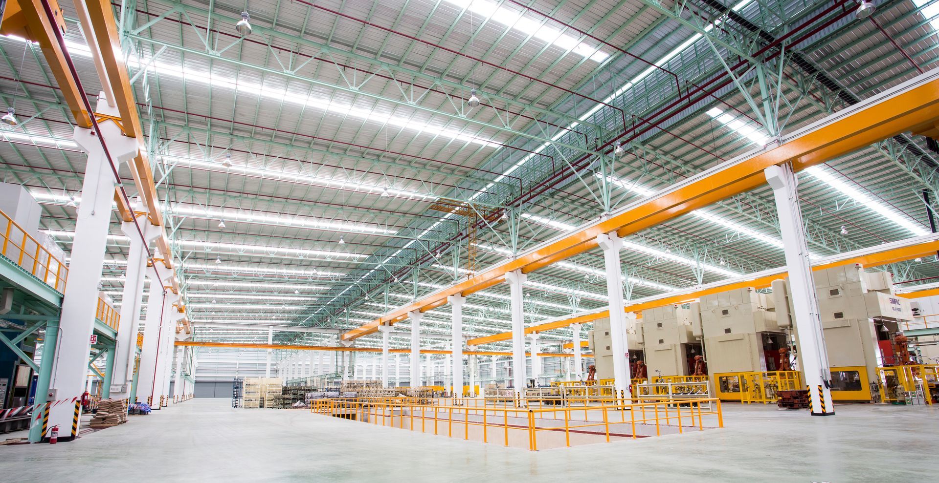 A large warehouse with a lot of machinery in it.