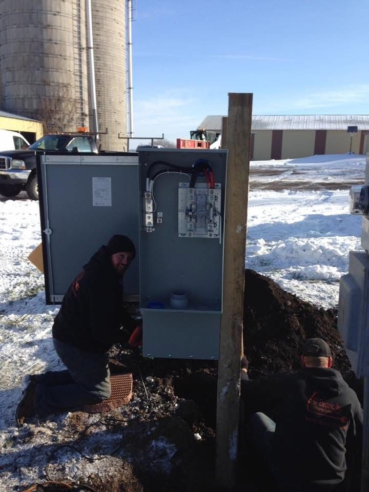 Two men are working on a box in the snow
