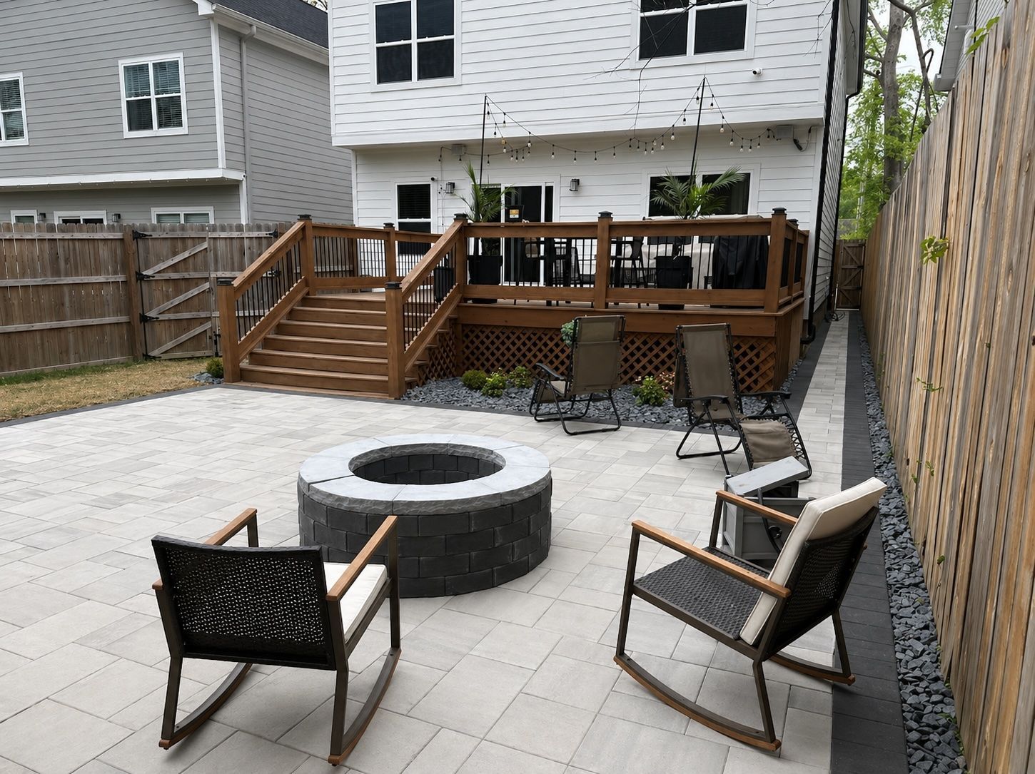 Back paver patio and outdoor living area with fire pit