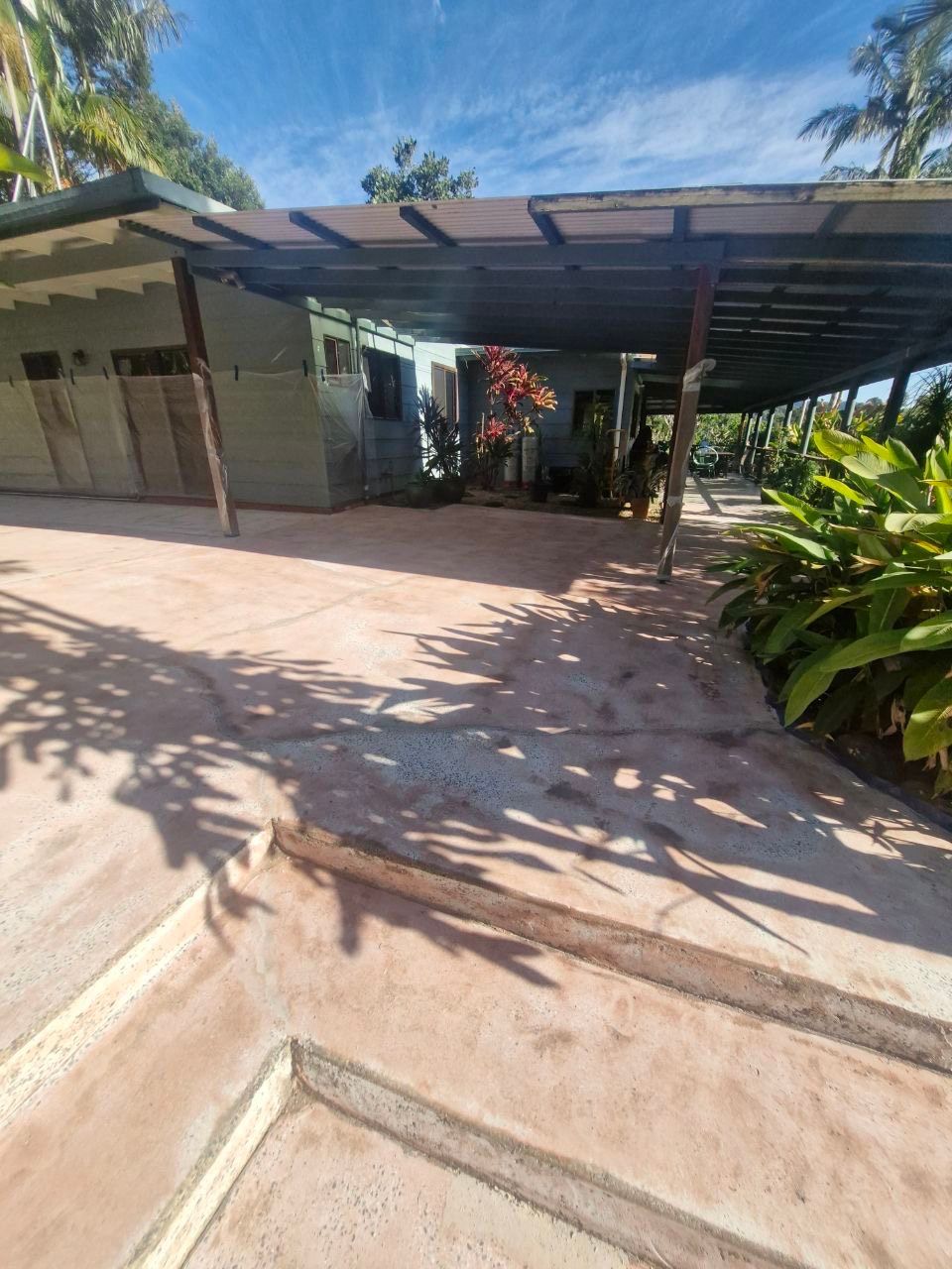 A driveway with a carport and a house in the background — Fantastic Frank's Concrete Resurfacing In Byron Bay, NSW