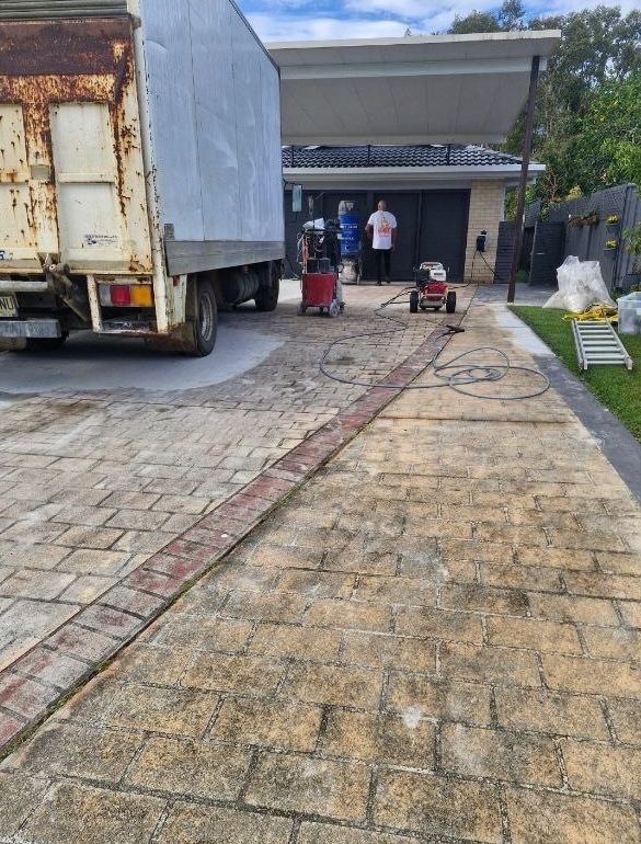 A white truck is parked in a driveway next to a house — Fantastic Frank's Concrete Resurfacing In Byron Bay, NSW