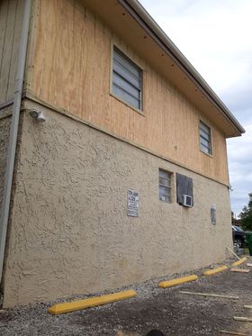 A large building with a lot of windows is being remodeled.