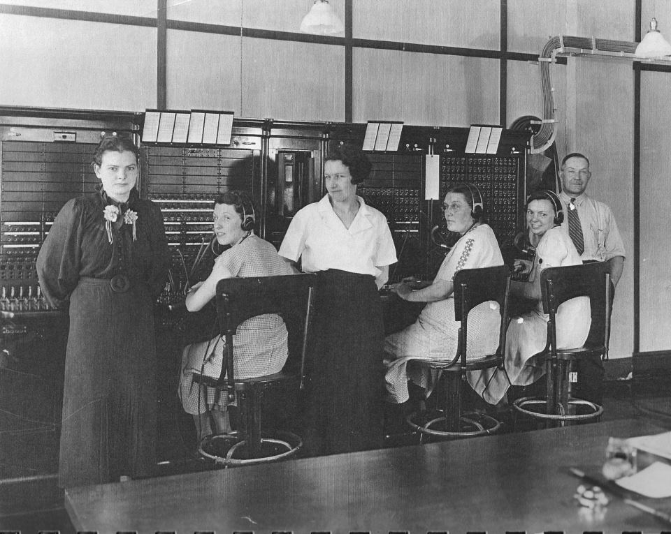 A black and white photo of a group of people in a room