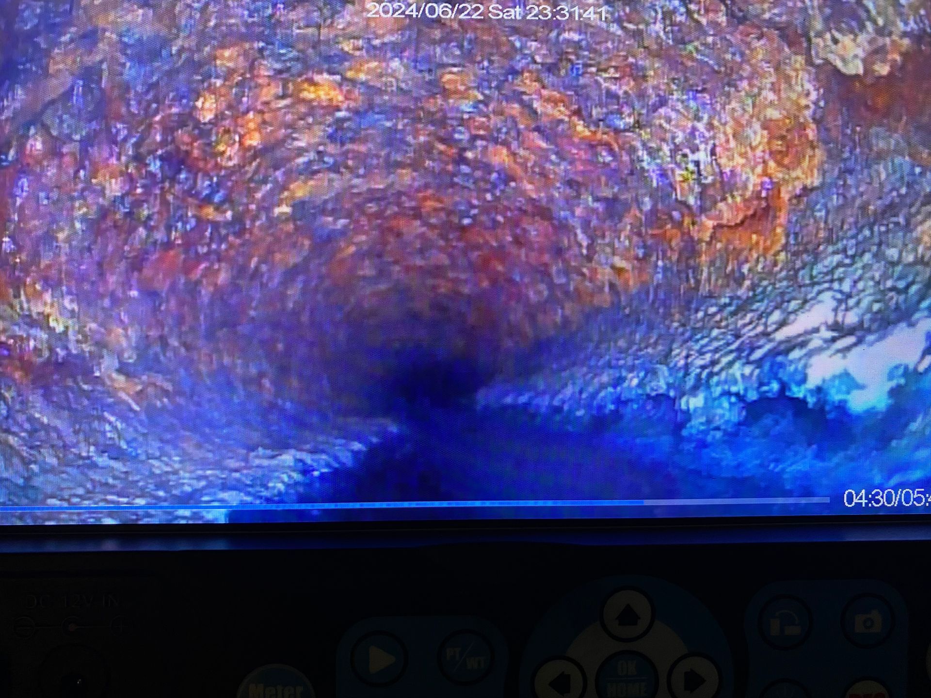 A computer screen shows a painting of a tunnel with a blue background.