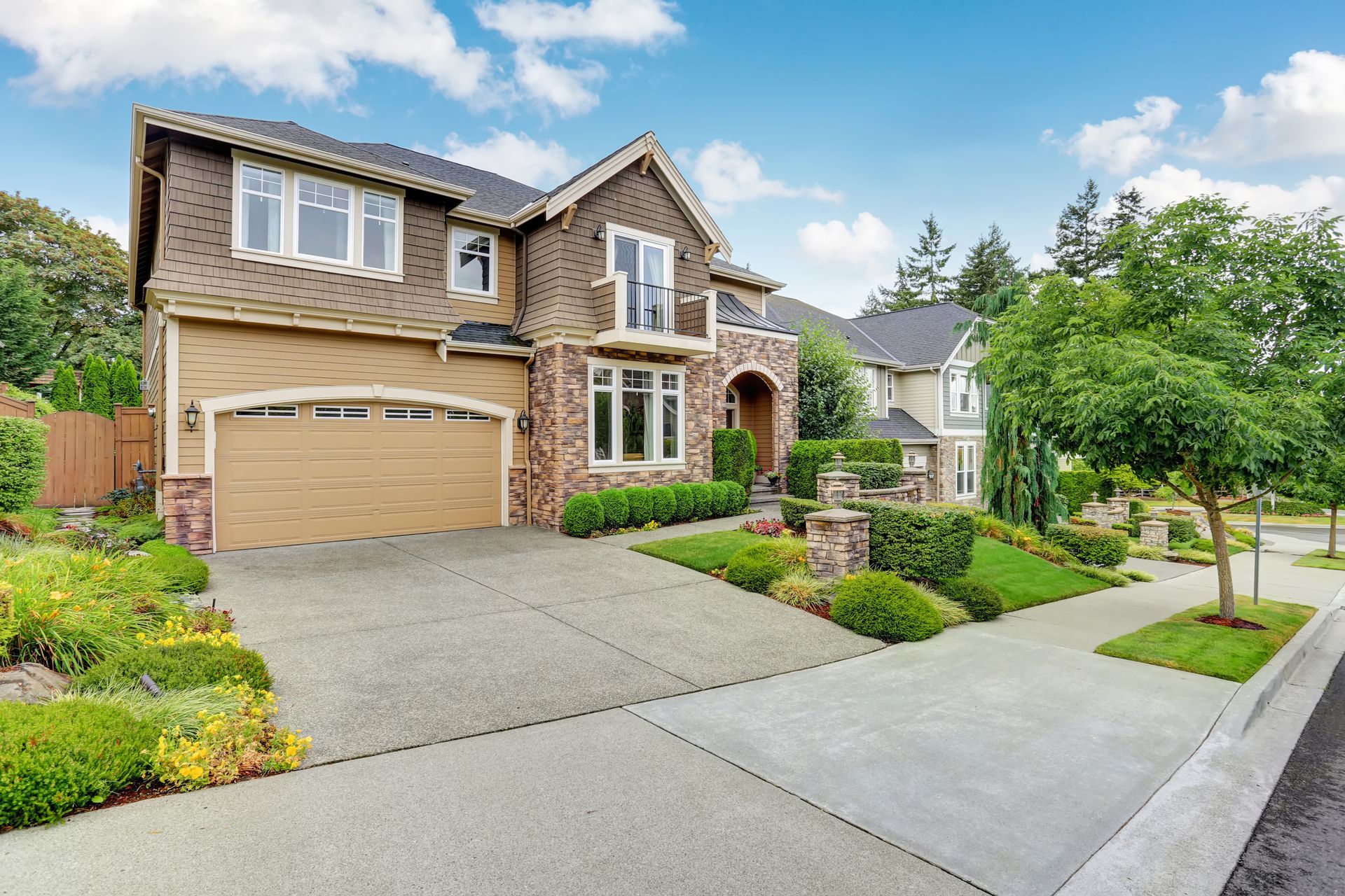A large house with a large driveway in front of it.