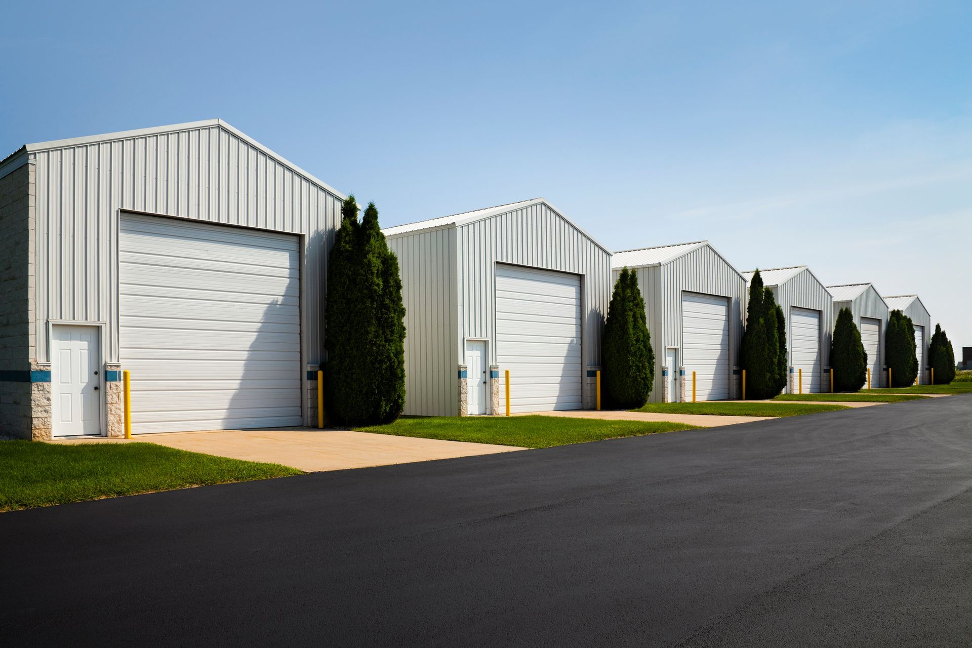 A row of warehouses with white garage doors