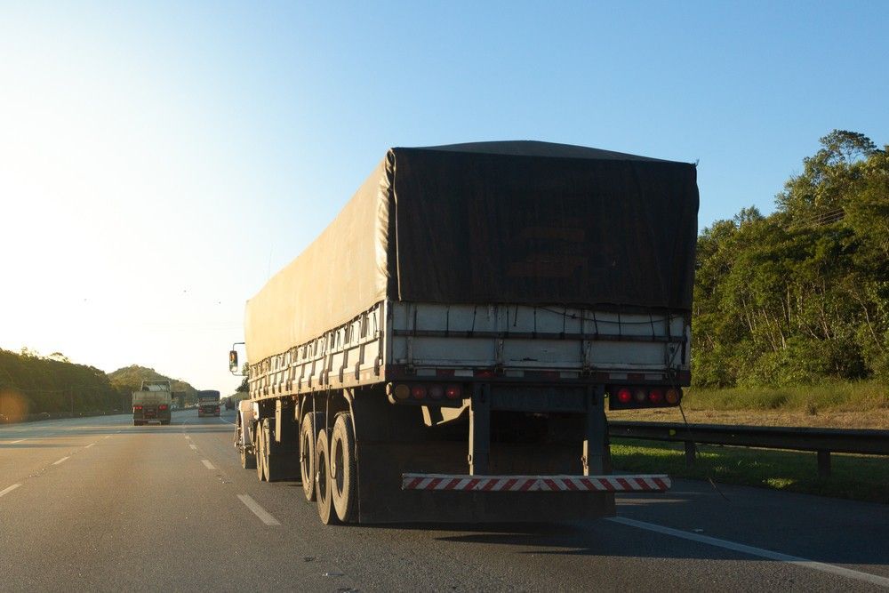 A Large Semi Truck is Driving Down a Highway — JEC Transport in Winnellie, NT