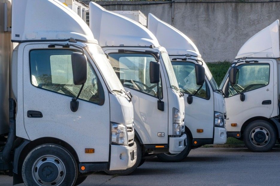 A Row of White Trucks Parked Next to Each Other — JEC Transport in Winnellie, NT