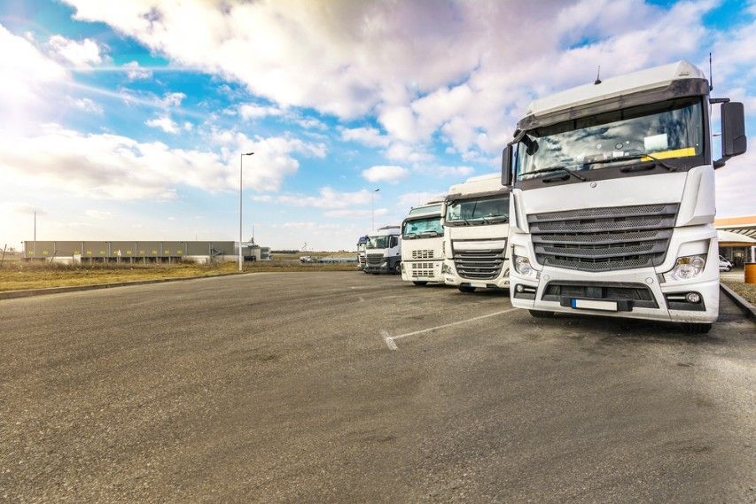 A Row of Semi Trucks Are Parked Outside — JEC Transport in Winnellie, NT