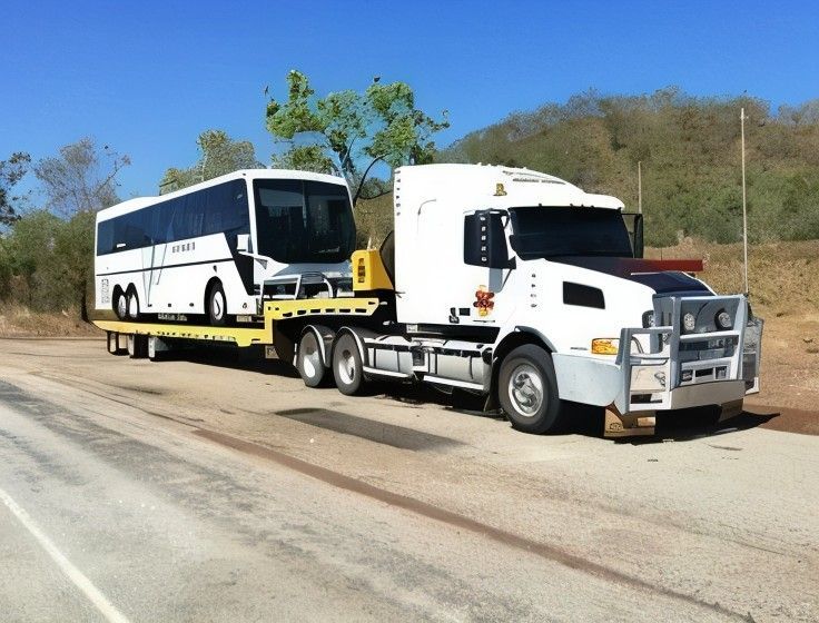 A Bus is Being Towed by a Semi Truck — JEC Transport in Winnellie, NT