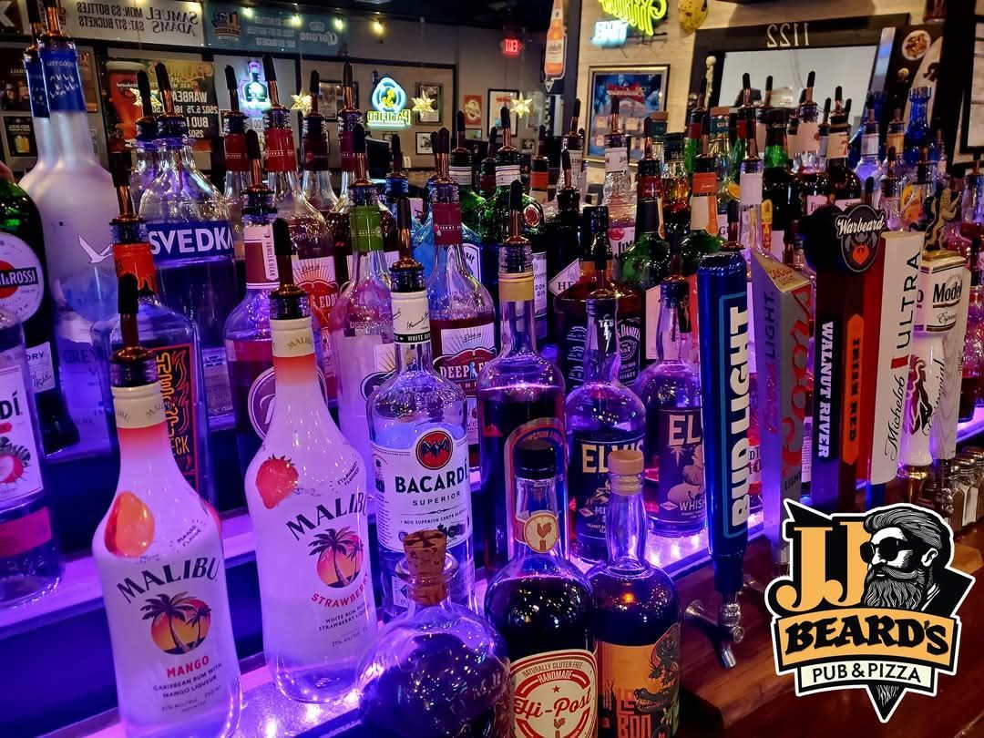 A bar filled with lots of bottles of alcohol.