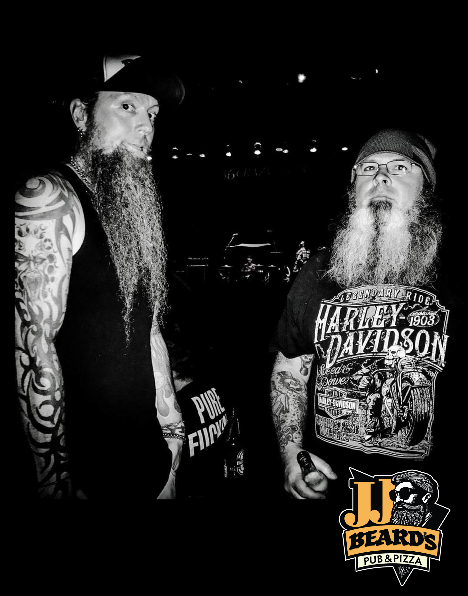 A man with a beard is wearing a harley davidson shirt