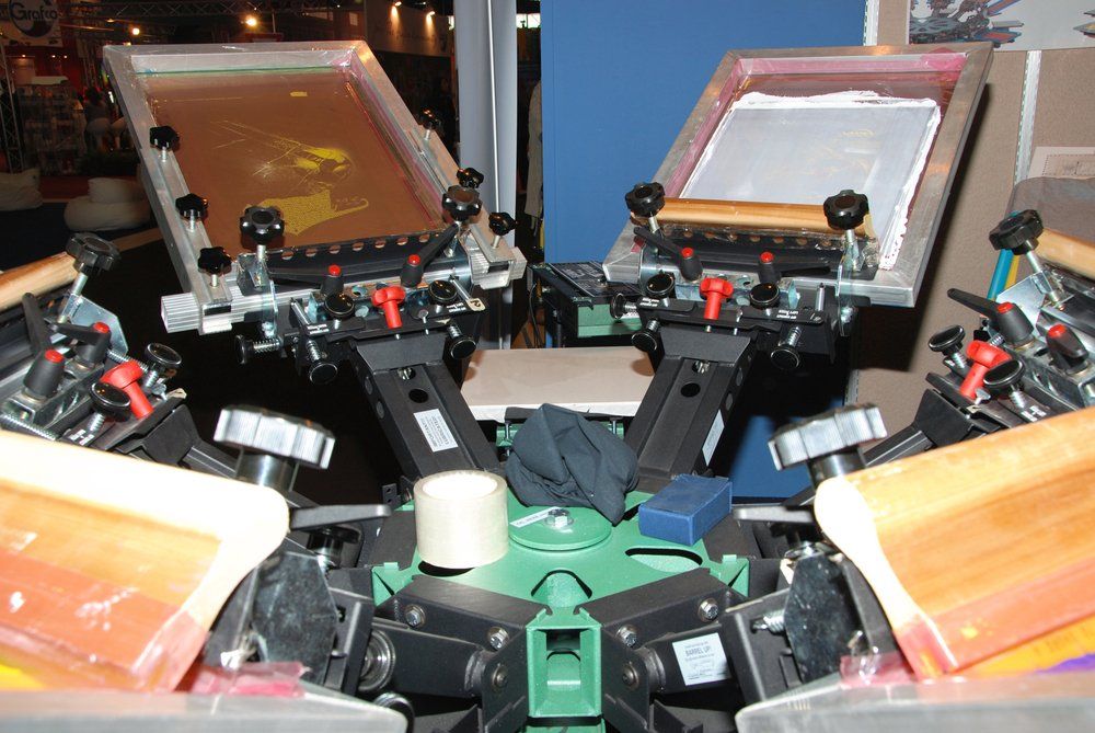 A screen printing machine with two screens on it