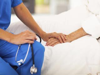 Home Healthcare Worker Holding Patient's Hand