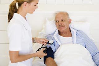 Home Healthcare Worker Checking Man's Blood Pressure