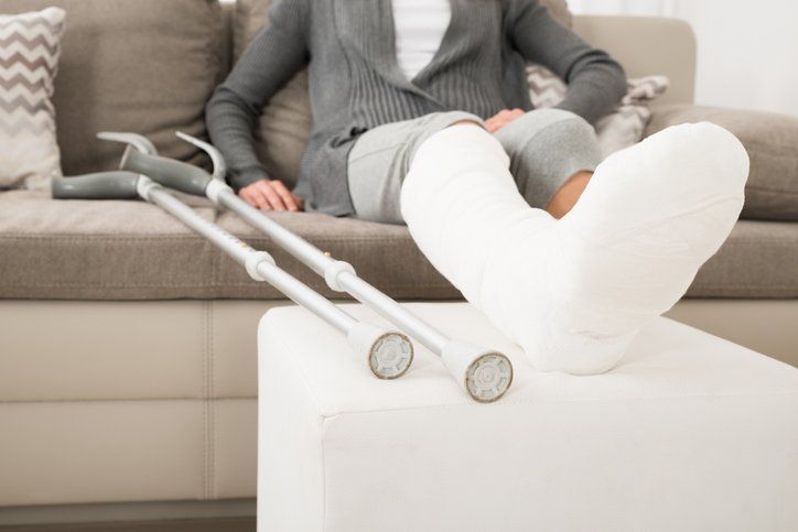 Lady With a Foot Cast Sitting on the Couch with Elevated Foot