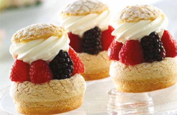 Dolci di pan di spagna con panna e frutta