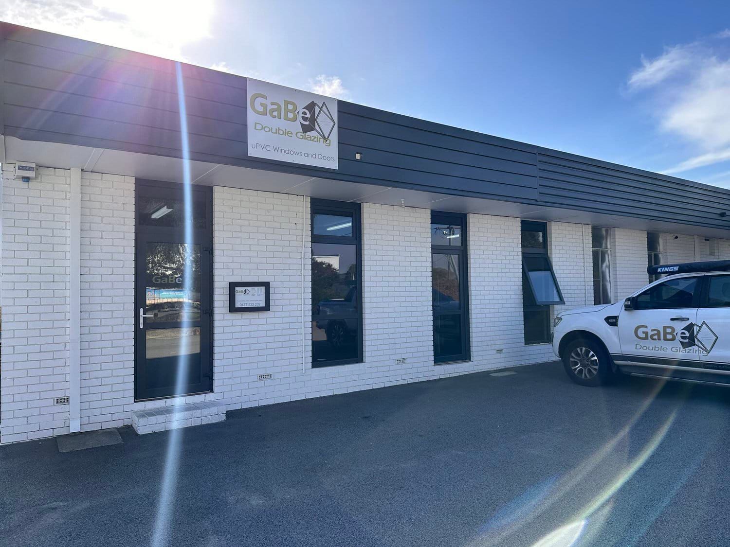 White building with black windows; 