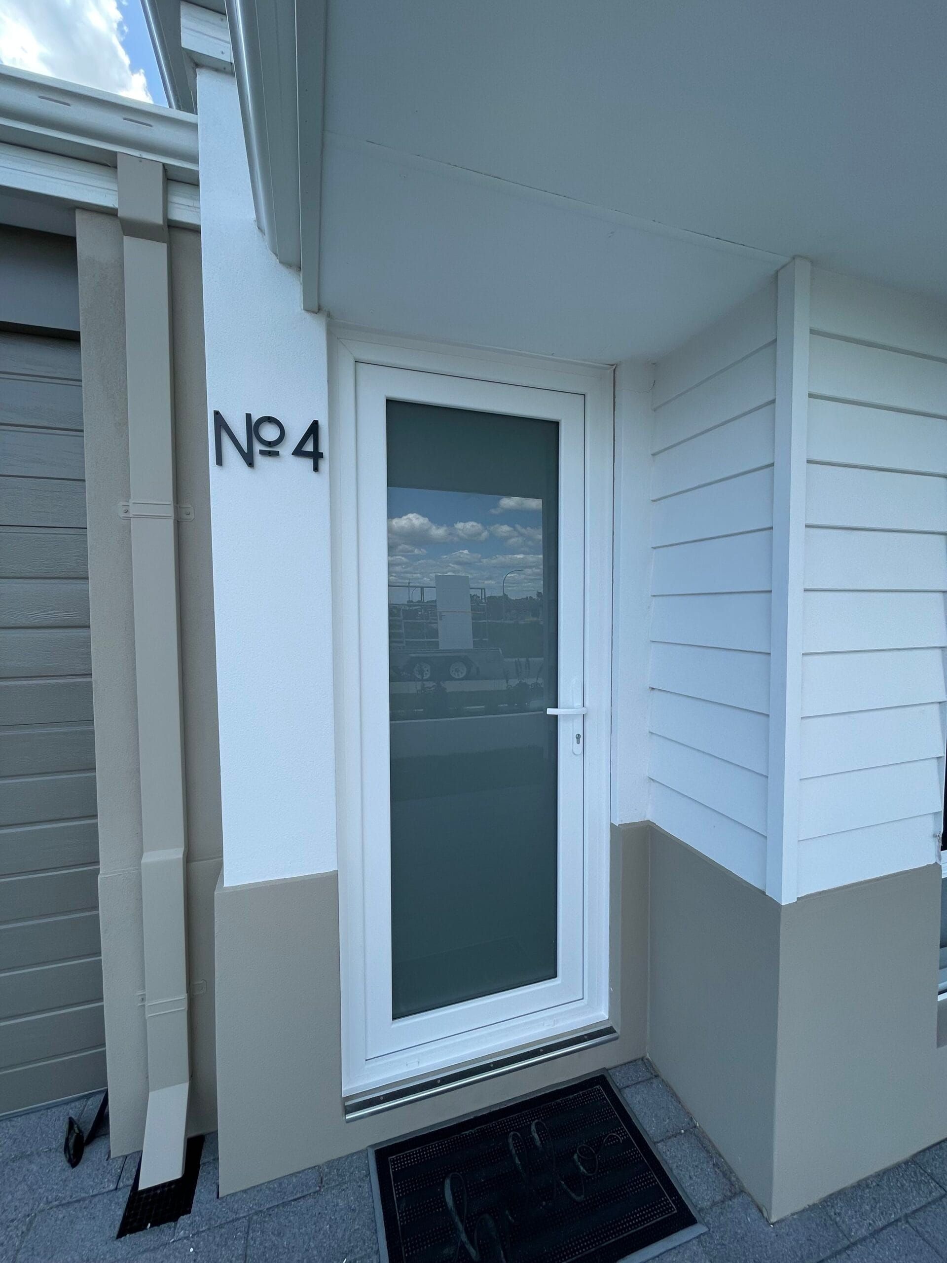 White front door with glass panel,