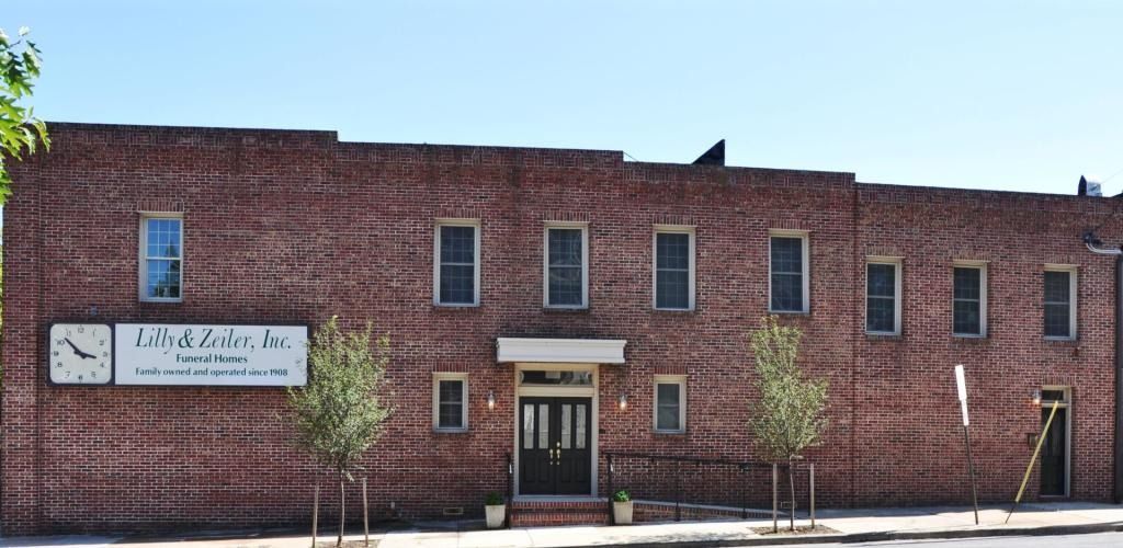Brick building with multiple windows; sign for 