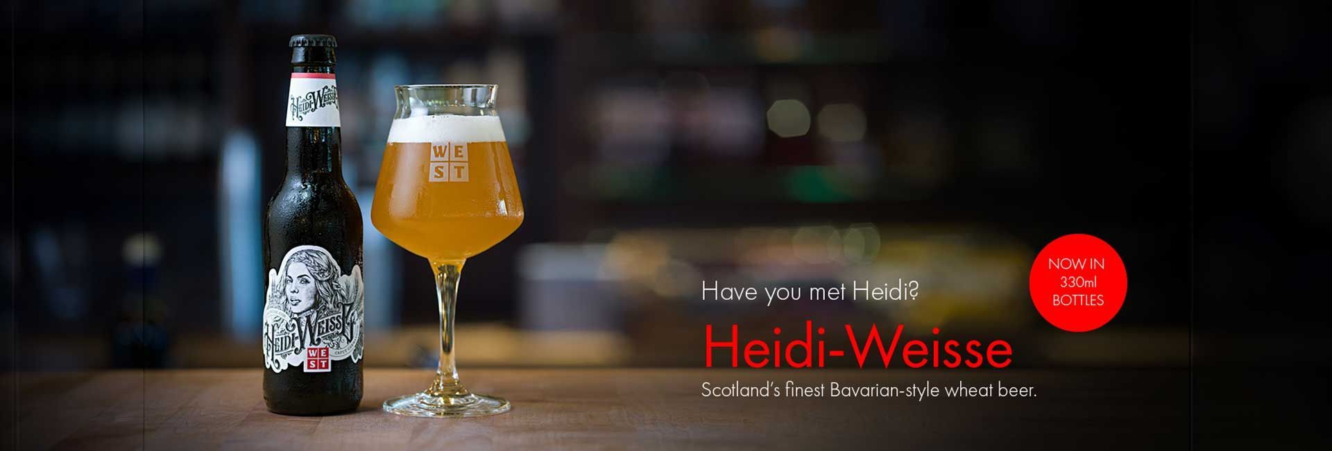 a bottle of heidi weisse next to a glass of beer