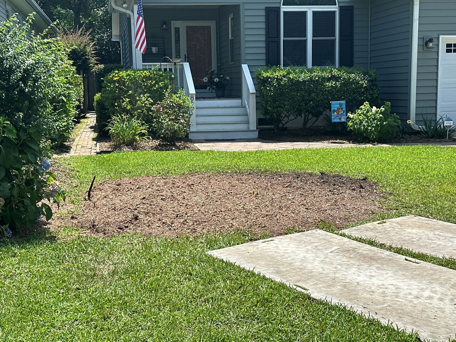 A house with a lot of grass in front of it.