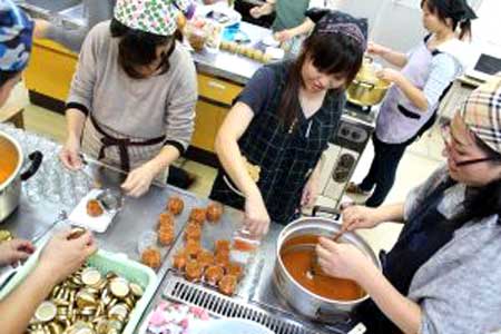 A group of people are preparing food in a kitchen.
