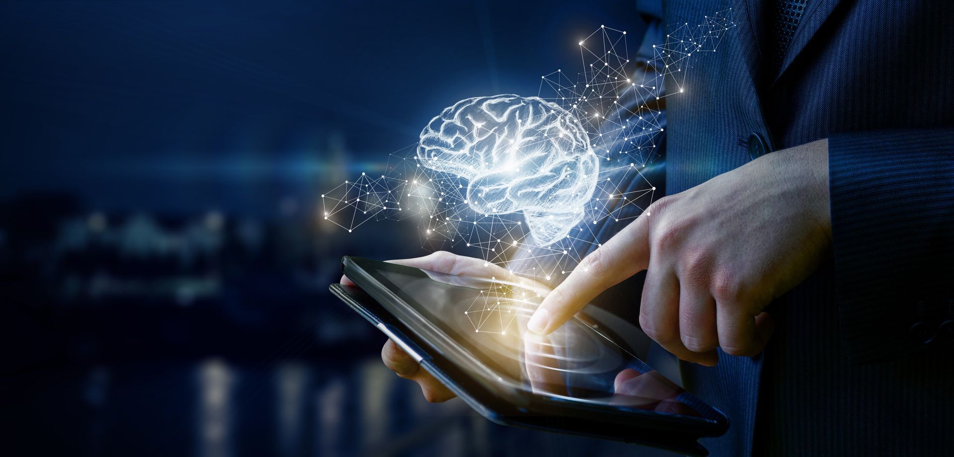 Business man pointing at a tablet with the touch point glowing and a image of a brain and lots of dots and lines connecting hovering above his finger.