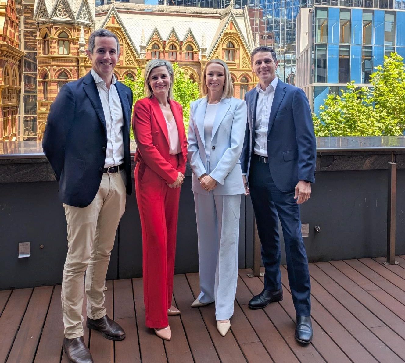 A group of people standing next to each other on a deck. From left to right, Luke, Alex, Clare and Trent from Davidson.