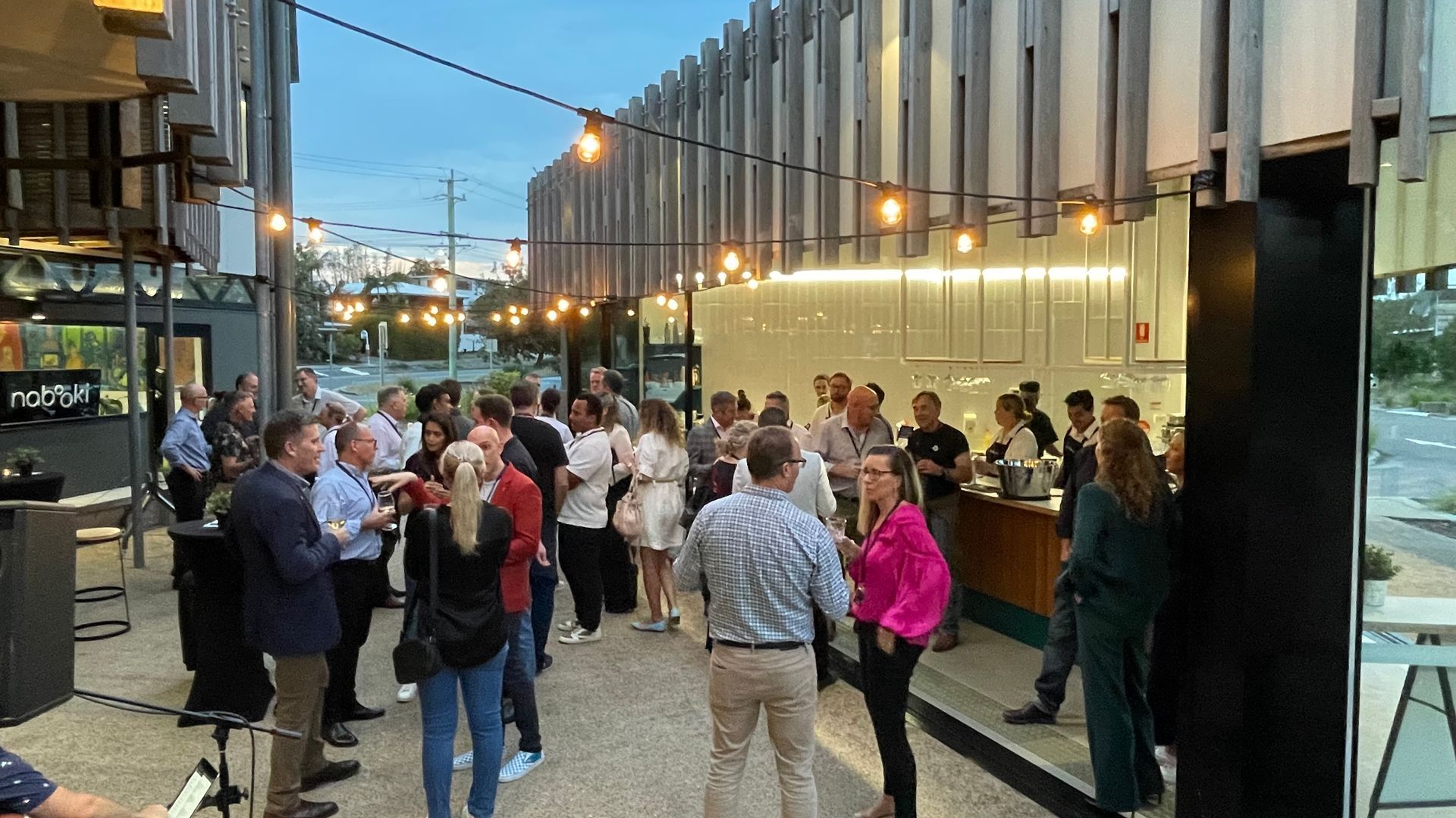 A group of people are standing outside of a building.