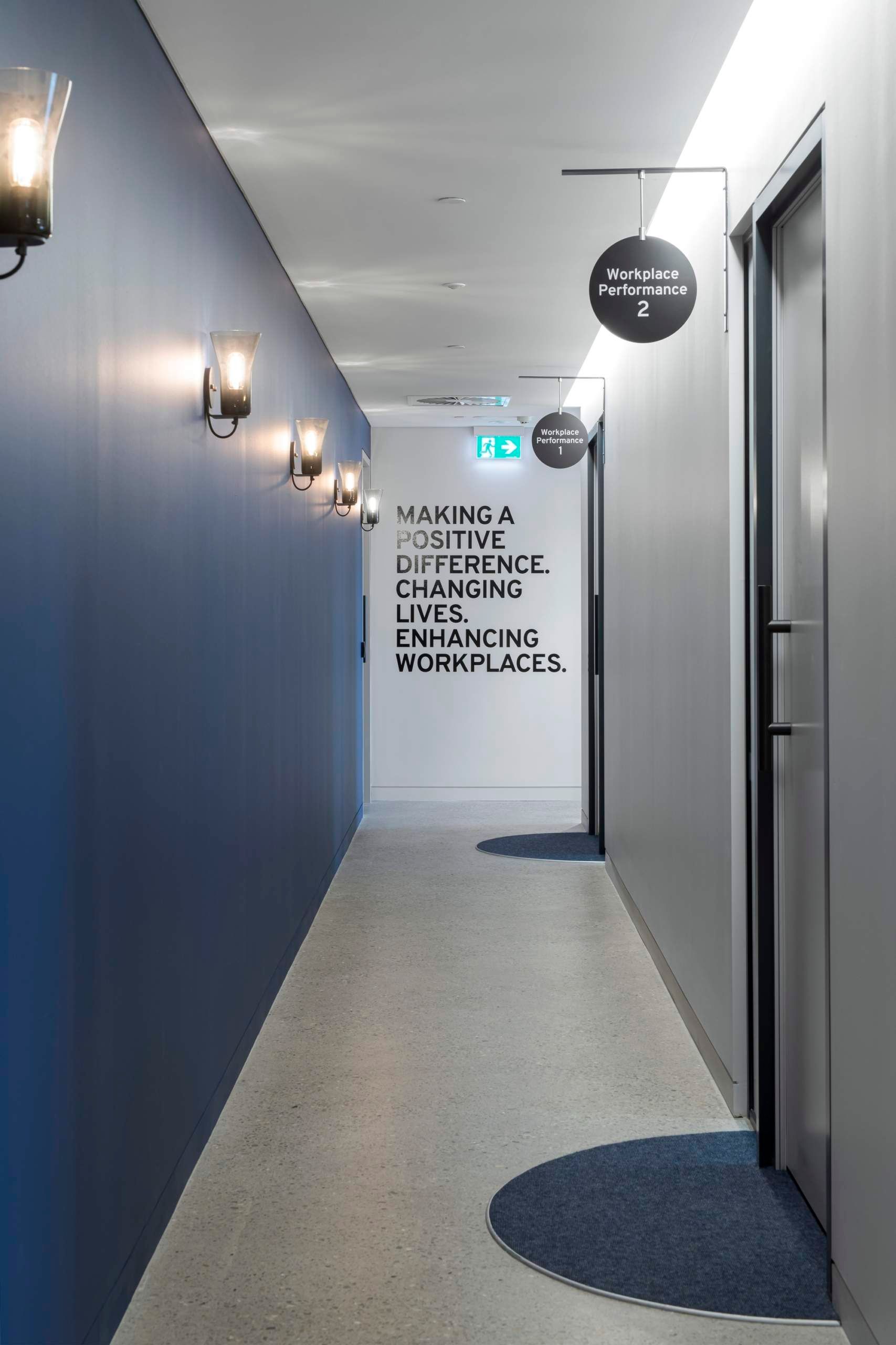 Davidson’s office hallway with the phrase “Making a positive difference. Changing lives. Enhancing workplaces.” on the wall.