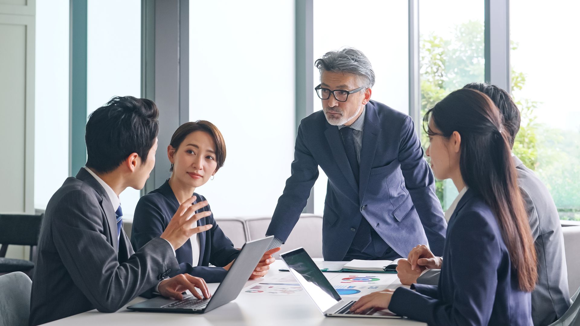 A group of business people are having a meeting in an office.