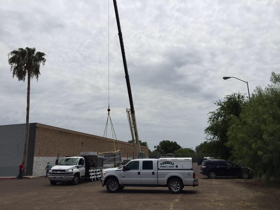 a crane is being used to lift a truck in a parking lot