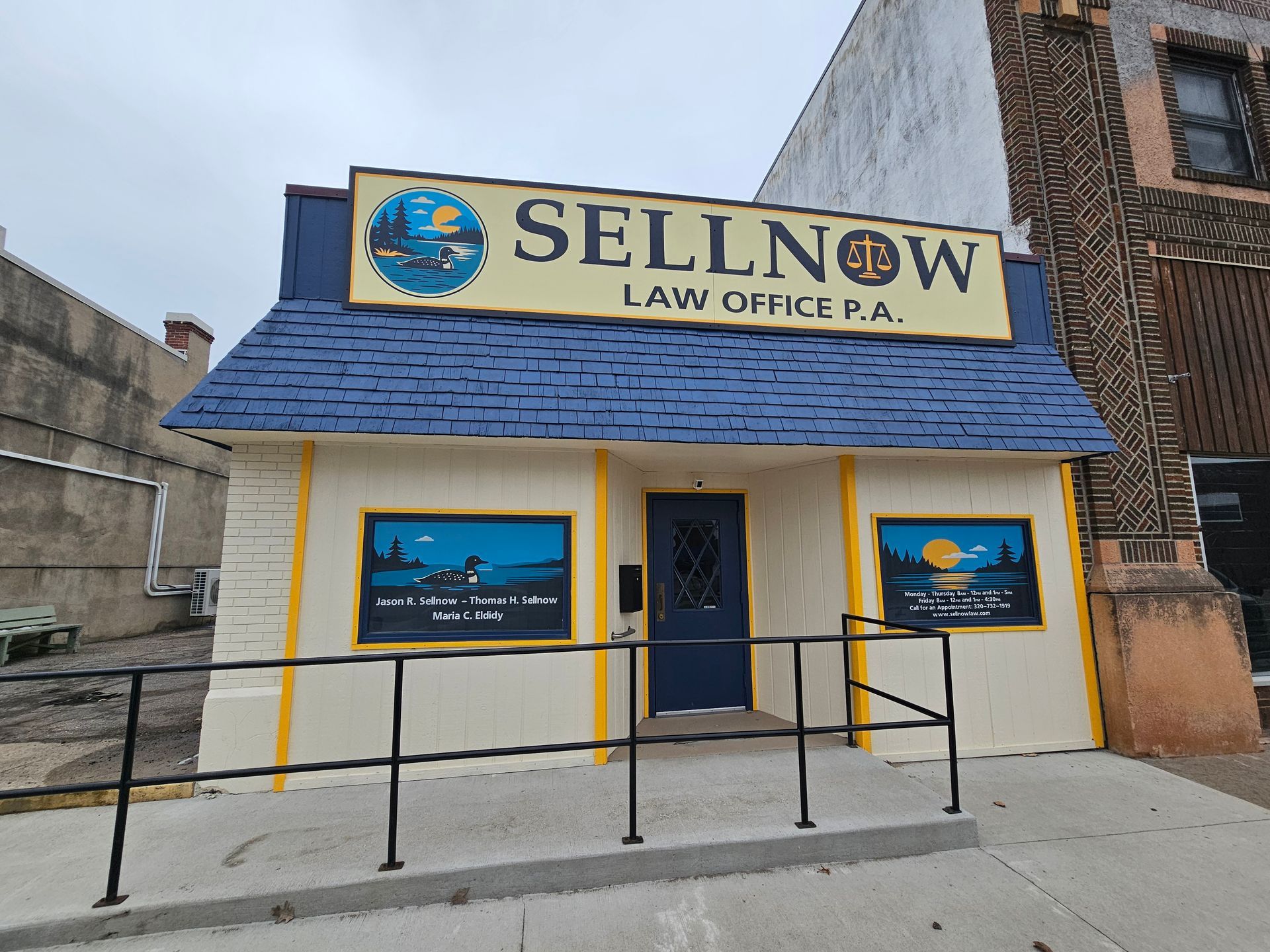 Man in gray hoodie consoles woman in white shirt on a couch.