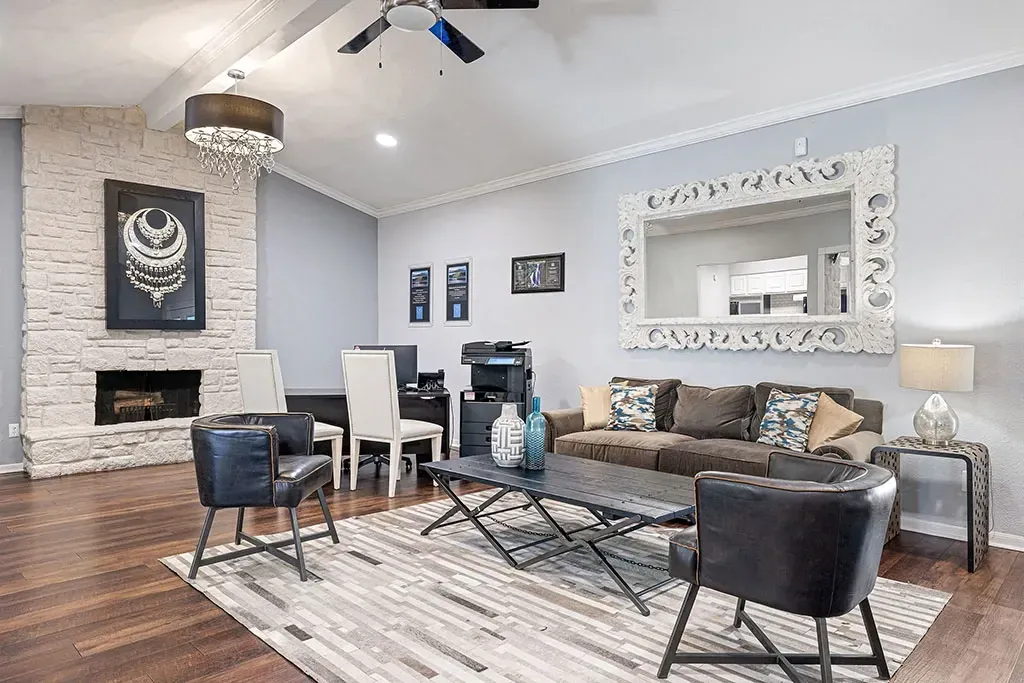 Comfortable living room with fireplace, sofa, and a large decorative mirror.