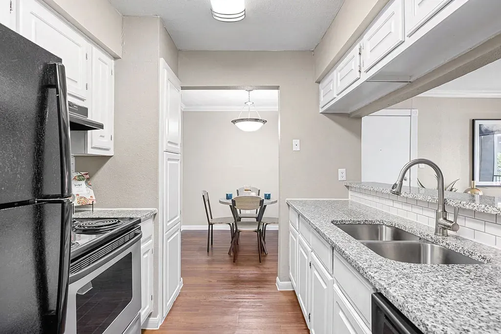 Modern kitchen with granite countertops and stainless steel appliances.
