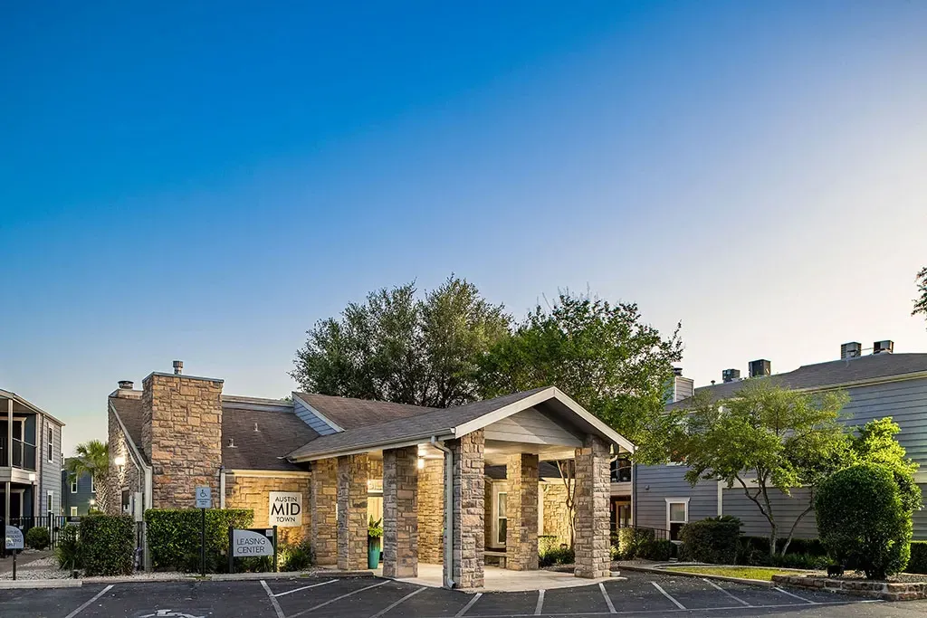 Austin Mid Town leasing center entrance with stone accents and covered walkway.