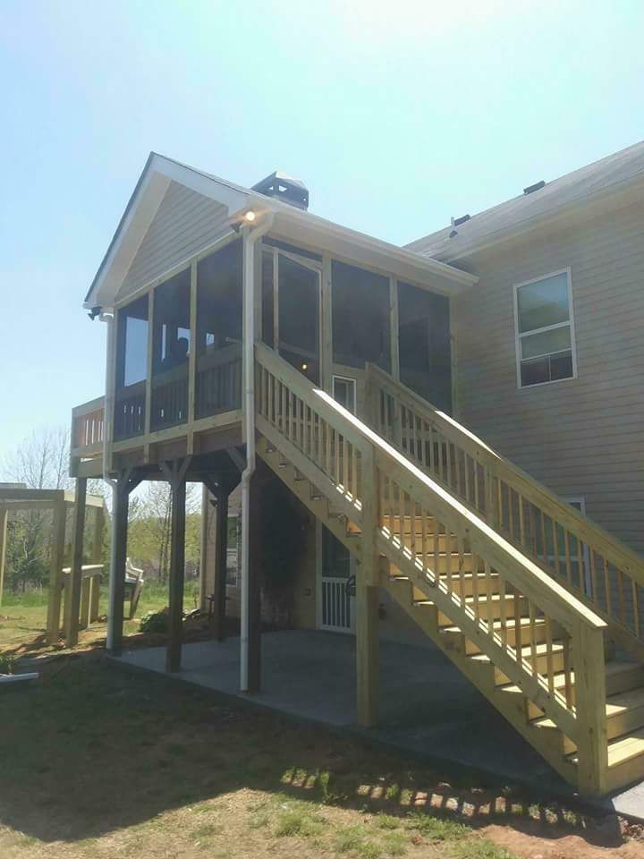 A house with a screened in porch and stairs