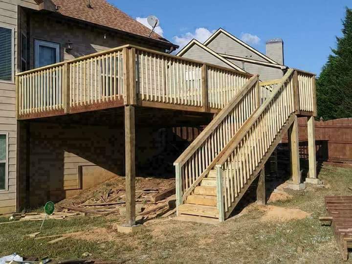 A wooden deck with stairs leading up to it