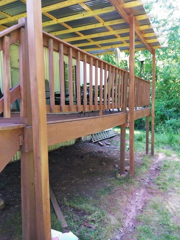 A wooden deck with a covered area underneath it