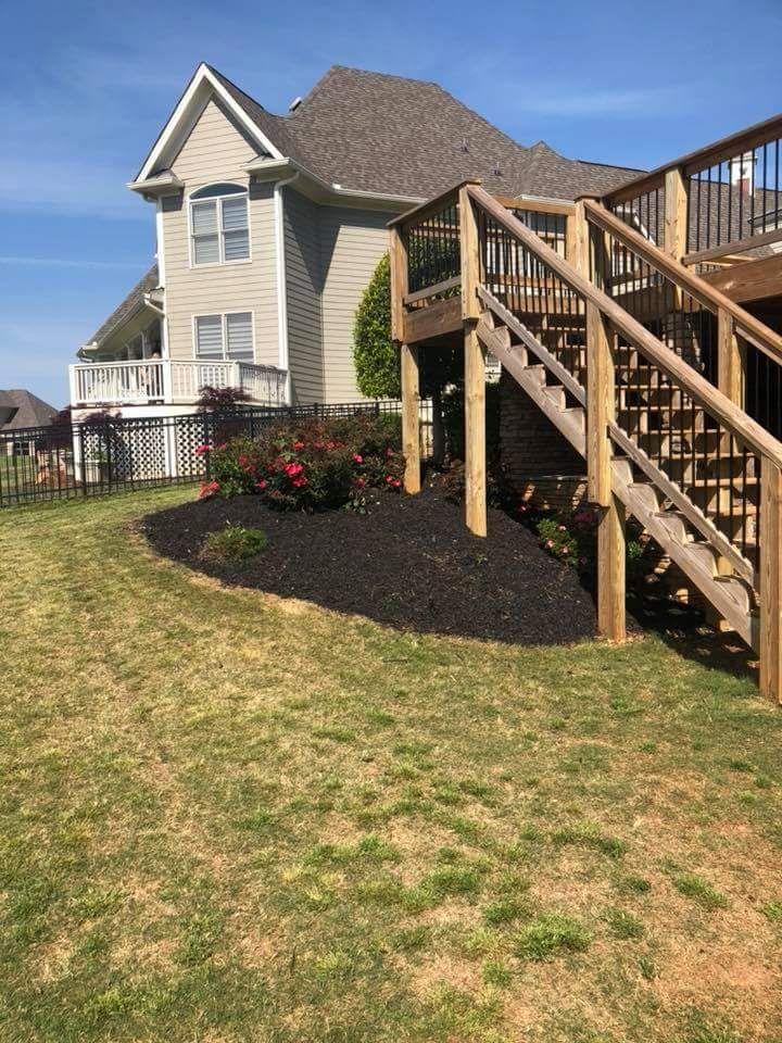 A house with a deck and stairs in front of it.