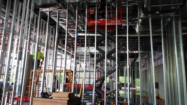 A large building under construction with a lot of metal beams.