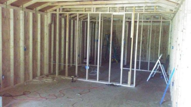 A room with a lot of wooden walls and a ladder.