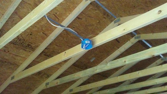 A close up of a wooden ceiling with a blue box on it.